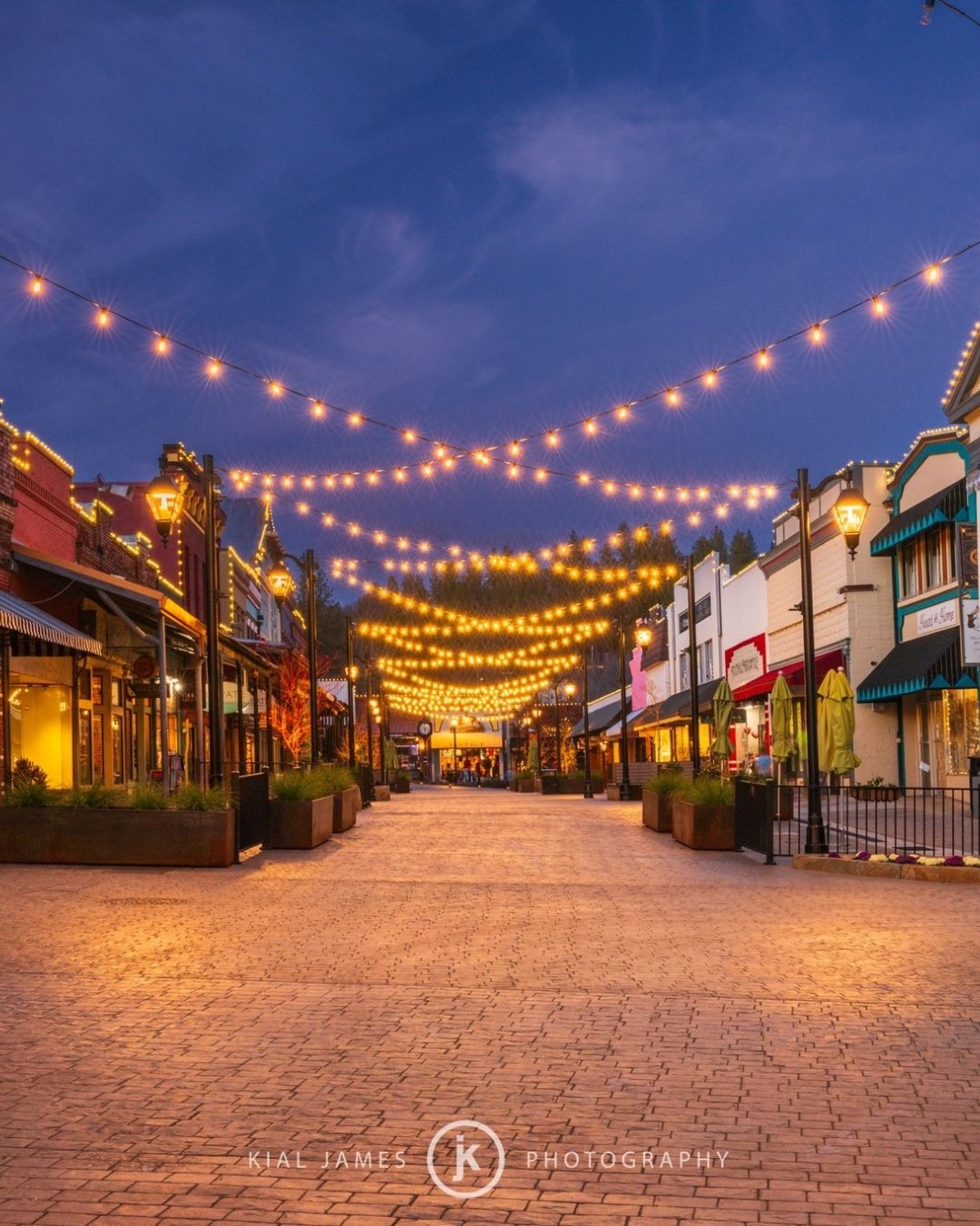String lights over brick walkway in downtown Grass Valley at dusk