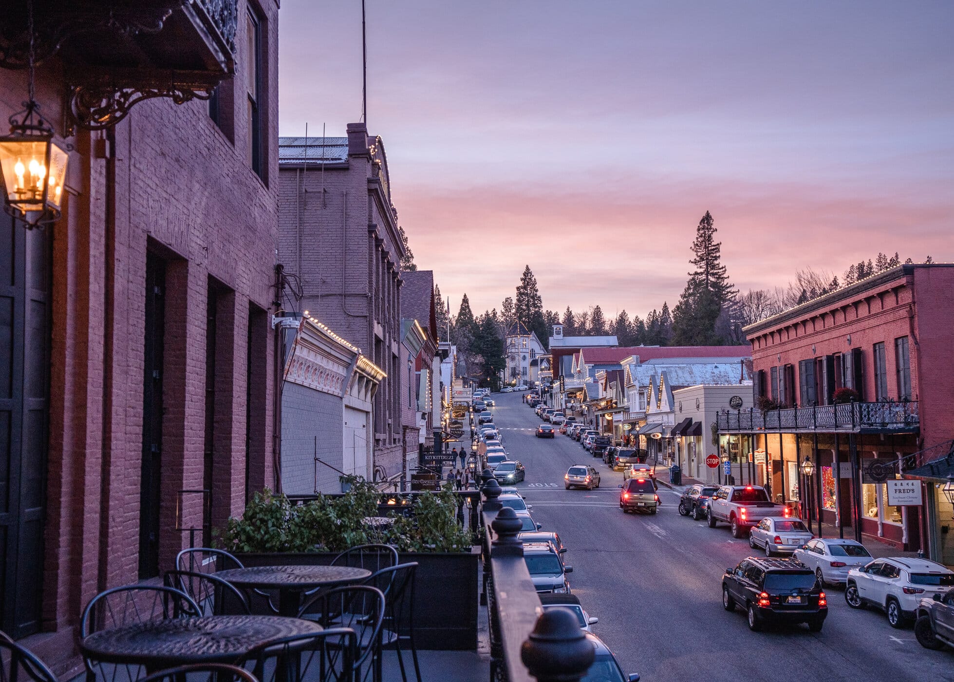 Downtown Nevada City at sunset with balcony seating and pink sky